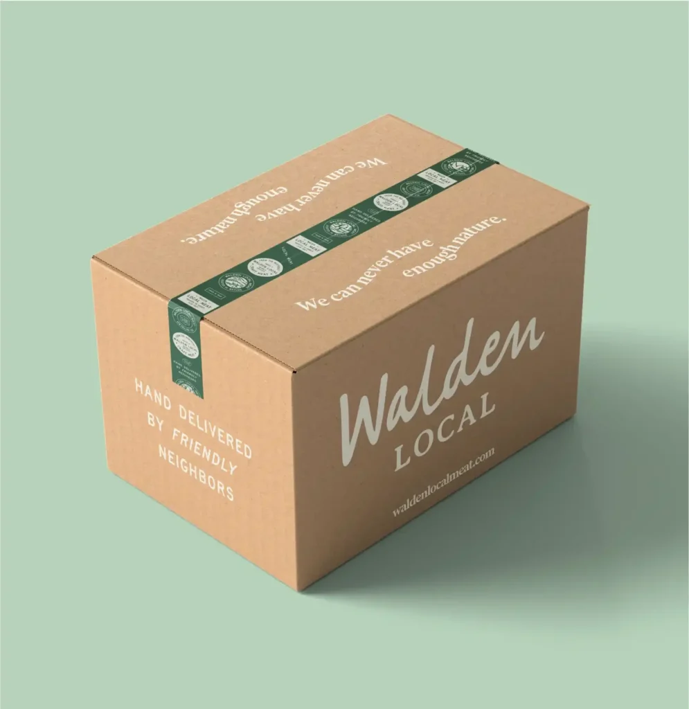 Branded Walden Local cardboard box with taglines on green background.