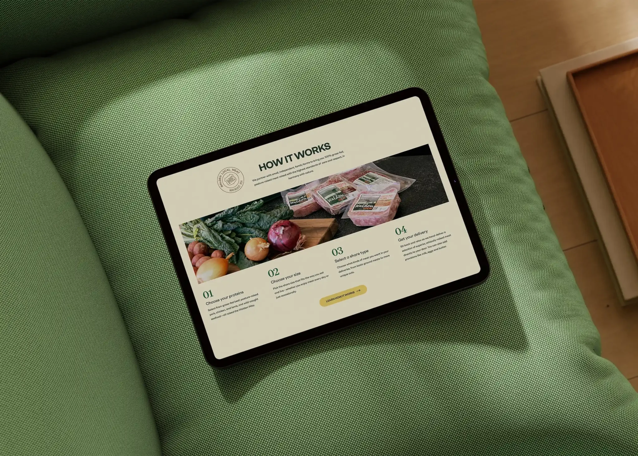 Tablet showing 'how it works' section on Walden Local website on a green couch.