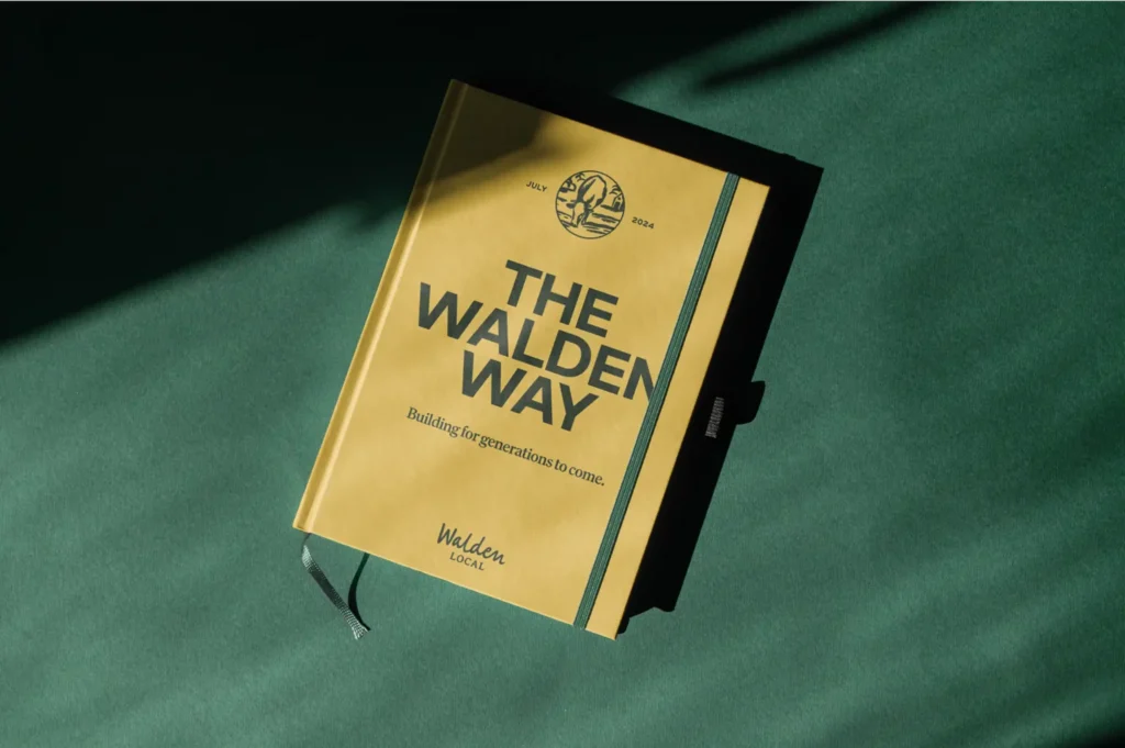 Branded book titled "The Walden Way" on dark green background, created by CPG branding agency.