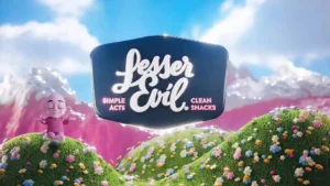 A cheerful, whimsical landscape with grassy hills, flowers, and two pink cartoon characters beside a sign reading Lesser Evil: Simple Acts, Clean Snacks against a bright sky and mountains.