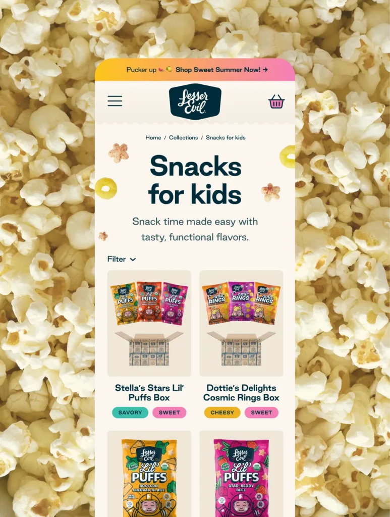 A mobile website screen for snacks for kids, displayed over a background of popcorn, shows colorful snack boxes and products for sale.