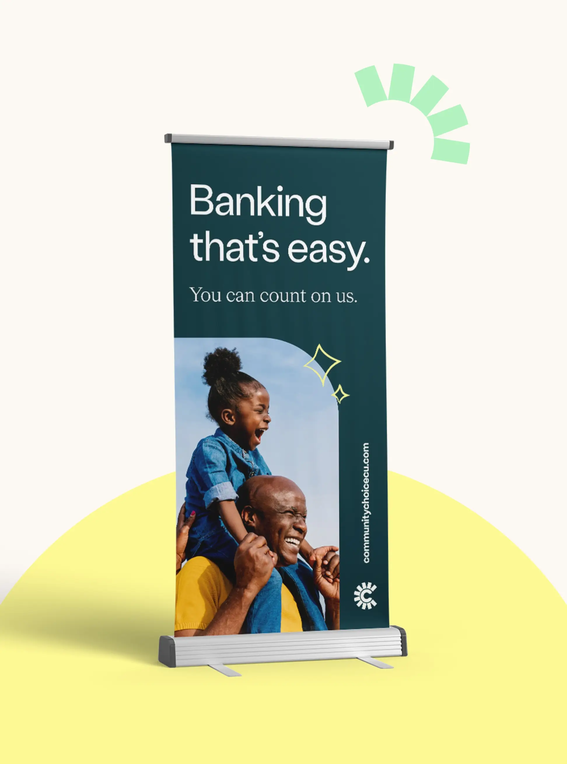 Vertical banner displaying Banking thats easy. You can count on us. above a smiling man carrying a laughing child on his shoulders, with graphic accents and a bank website link.