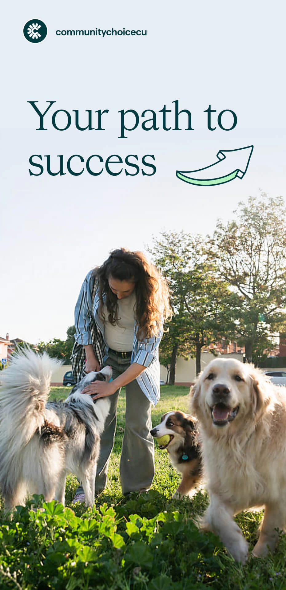 A woman pets two dogs in a grassy park on a sunny day, with the text “Your path to success” and a Community Choice Credit Union logo above.