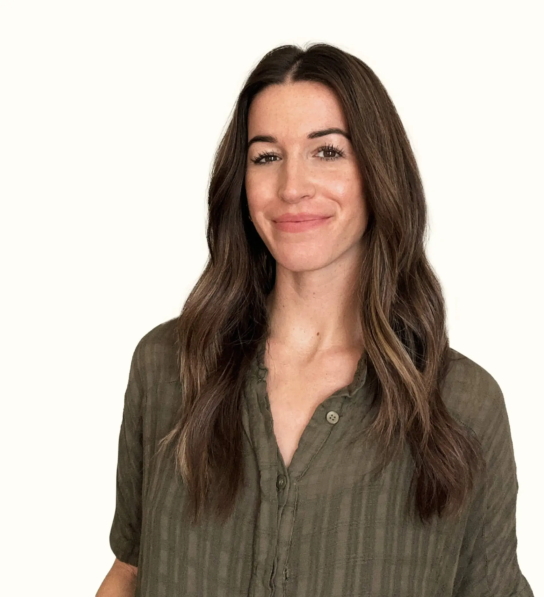 A woman with long brown hair, wearing an olive green button-up shirt, smiles gently at the camera against a plain light background.
