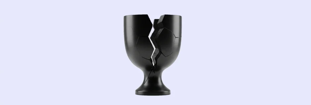 A black ROAS trophy with multiple large cracks stands upright against a plain light purple background, symbolizing the contrast between ROAS vs incrementality.