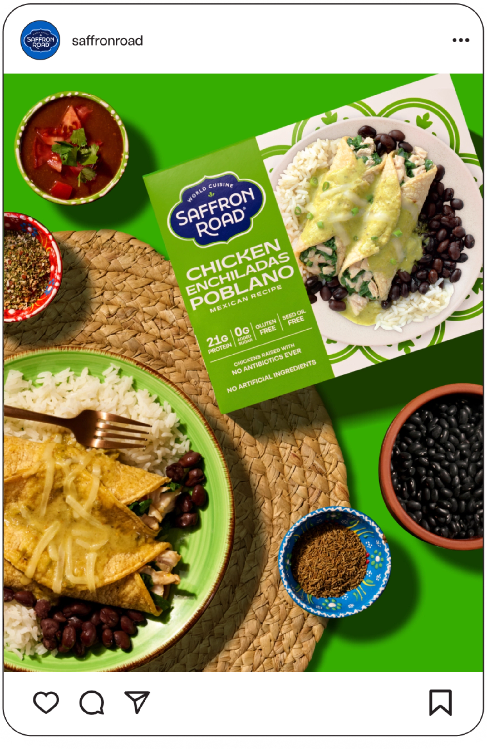 A Saffron Road Chicken Enchiladas Poblano frozen meal is shown plated with rice and black beans, surrounded by salsa, black beans, and seasonings on a vibrant green background.